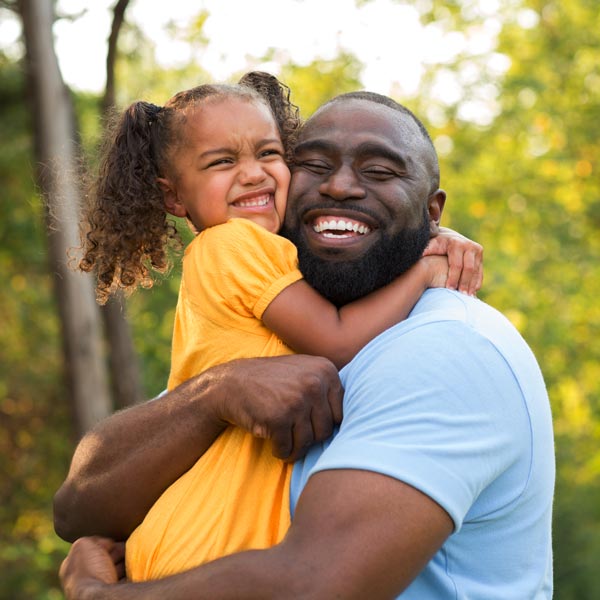 father and daughter smiling