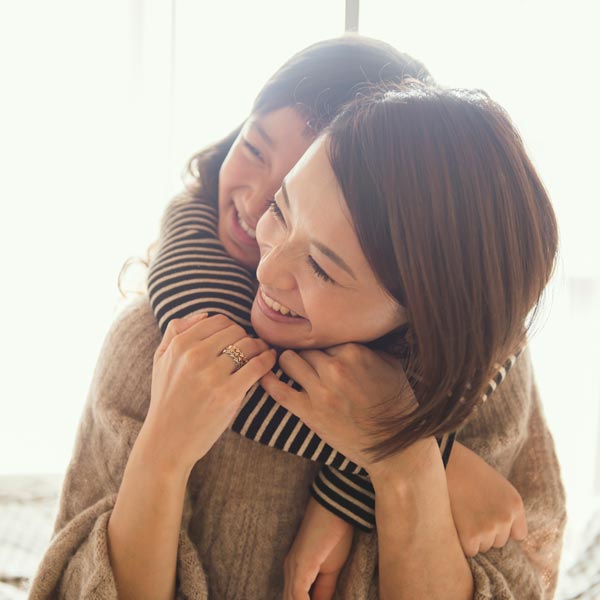 mother and daughter smiling