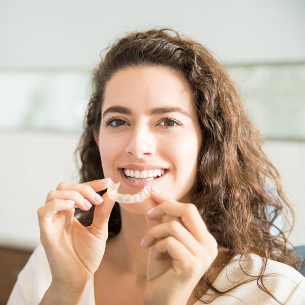 woman with clear aligners