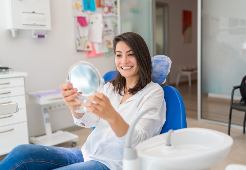 Woman smiling after getting a temporary dental filling in Moberly, MO